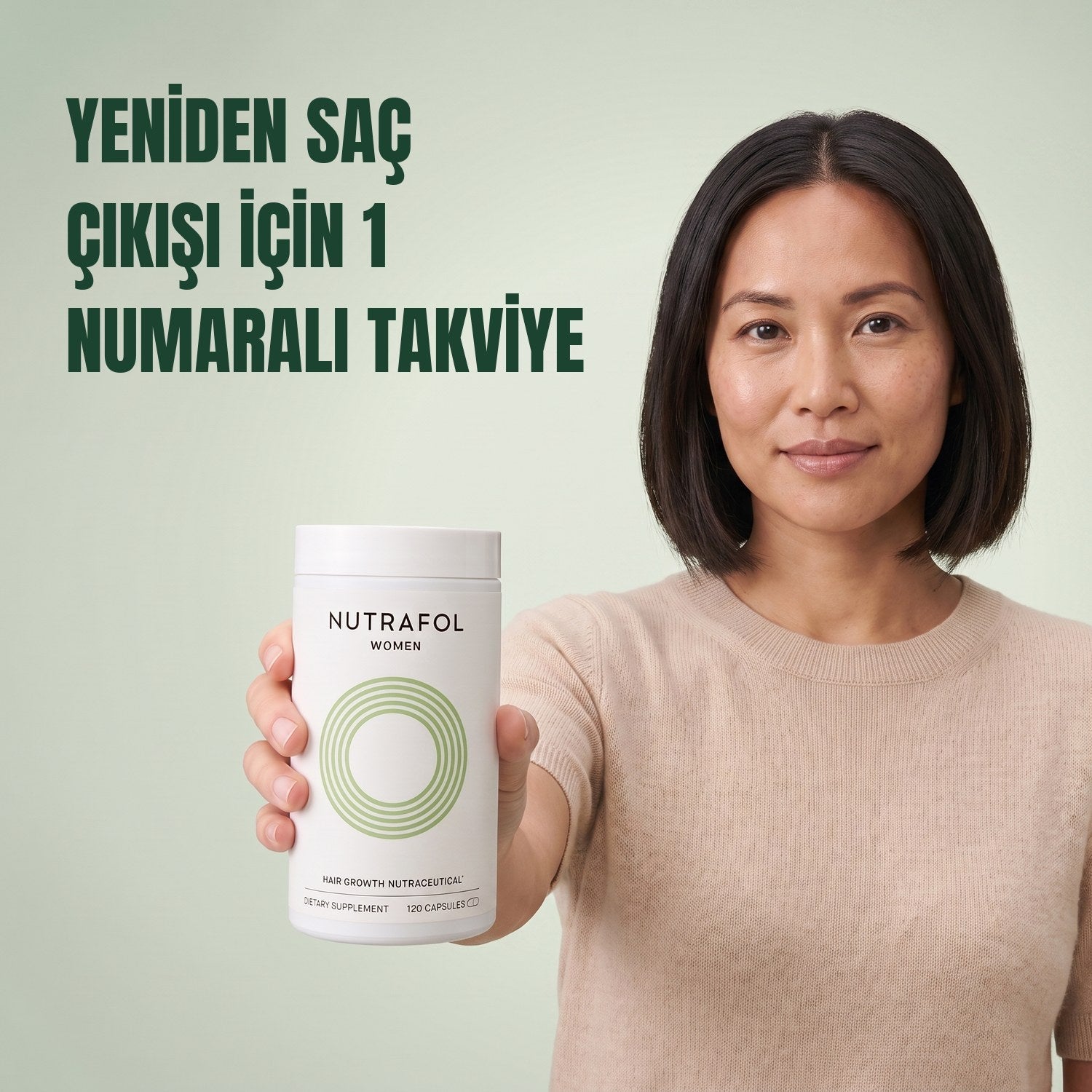 Woman holding the Nutrafol for Women 18-44 supplement box against a green background