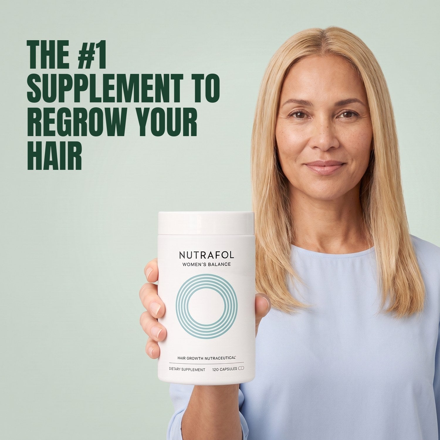 Woman holding the Nutrafol for Women 45+ supplement box against a green background