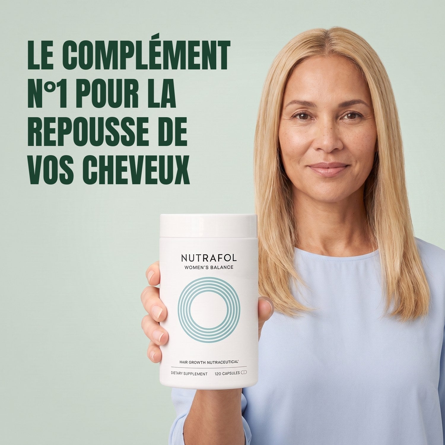 Woman holding the Nutrafol for Women 45+ supplement box against a green background