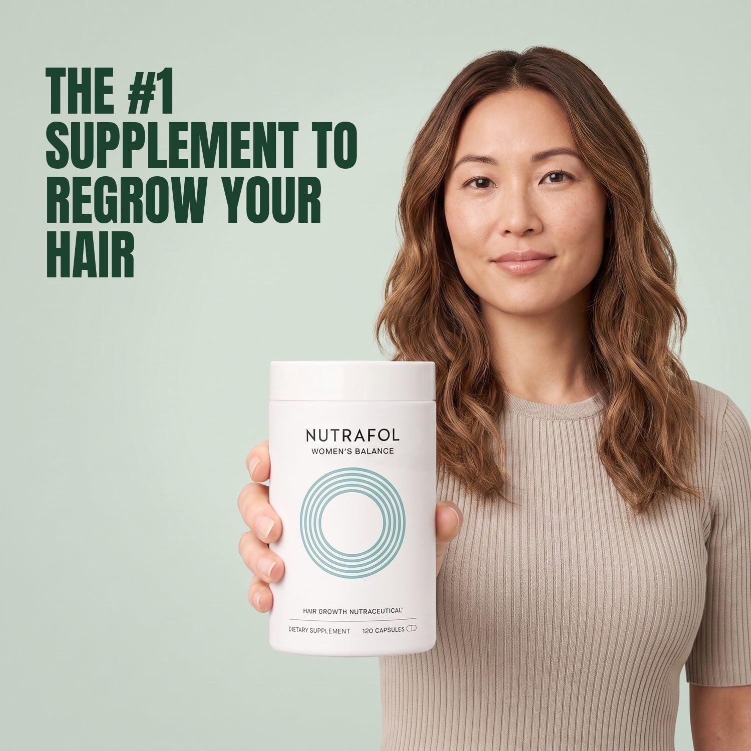 Woman holding the Nutrafol for Women 45+ supplement box against a green background