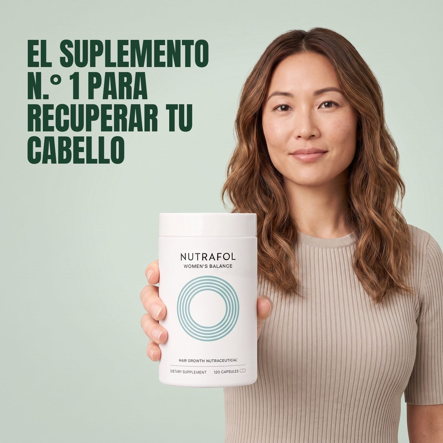 Woman holding the Nutrafol for Women 45+ supplement box against a green background