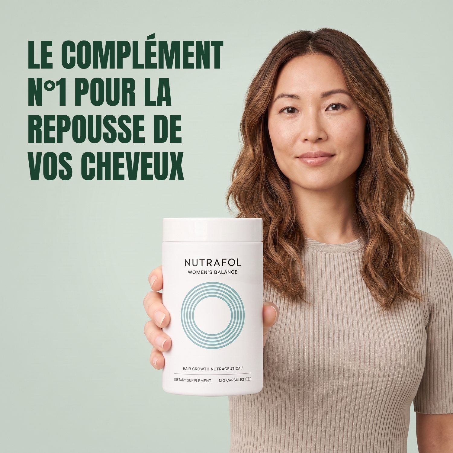 Woman holding the Nutrafol for Women 45+ supplement box against a green background