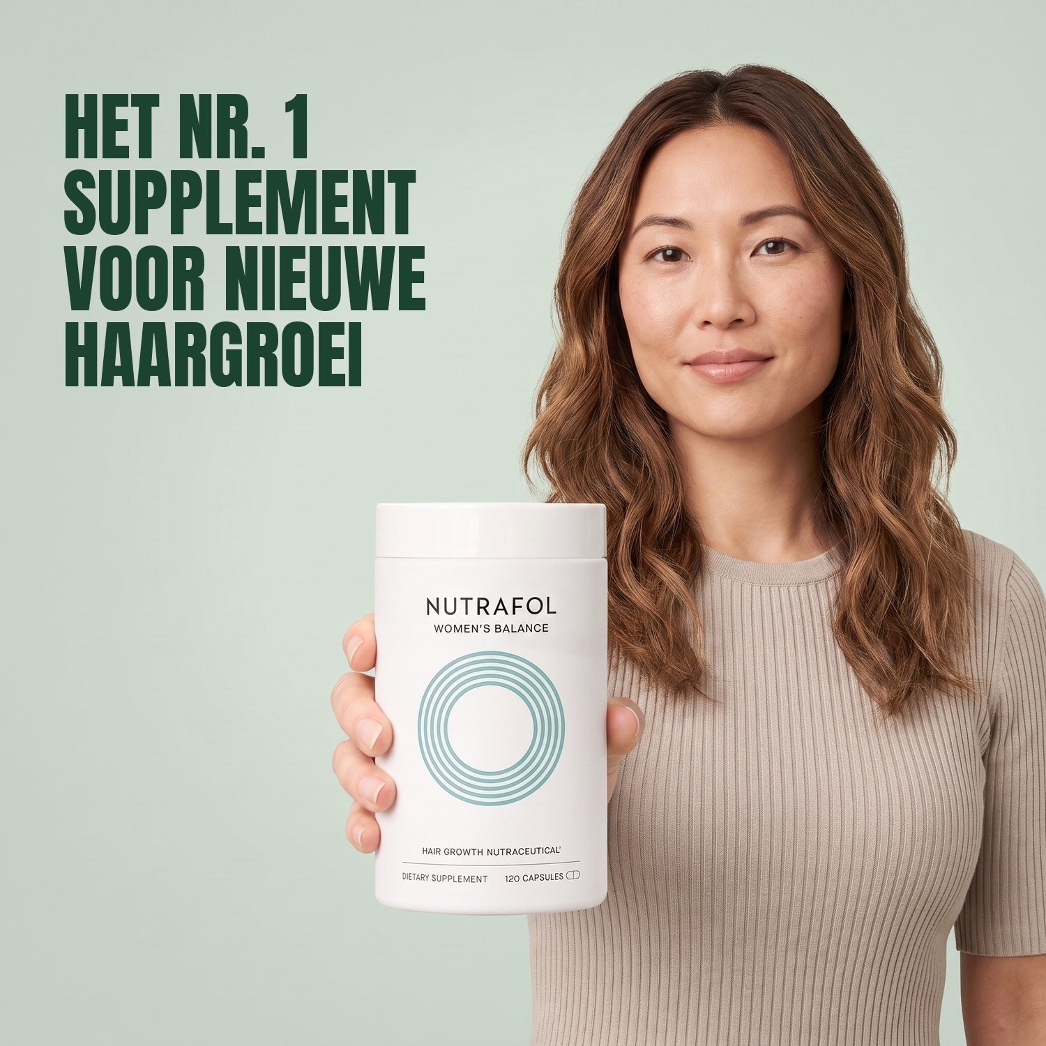 Woman holding the Nutrafol for Women 45+ supplement box against a green background