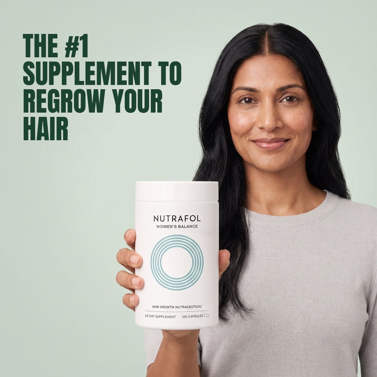 Woman holding the Nutrafol for Women 45+ supplement box against a green background