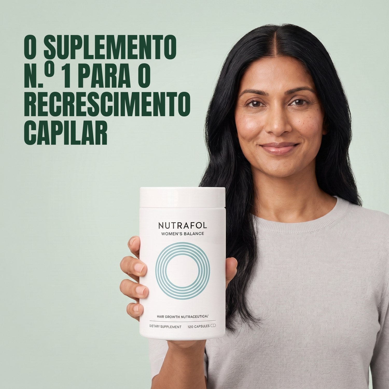 Woman holding the Nutrafol for Women 45+ supplement box against a green background