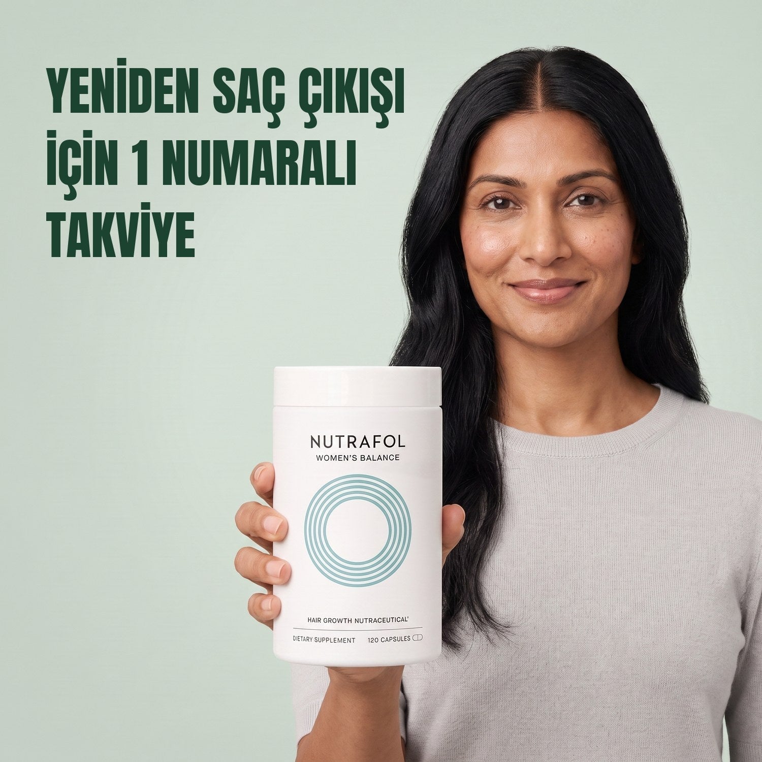 Woman holding the Nutrafol for Women 45+ supplement box against a green background