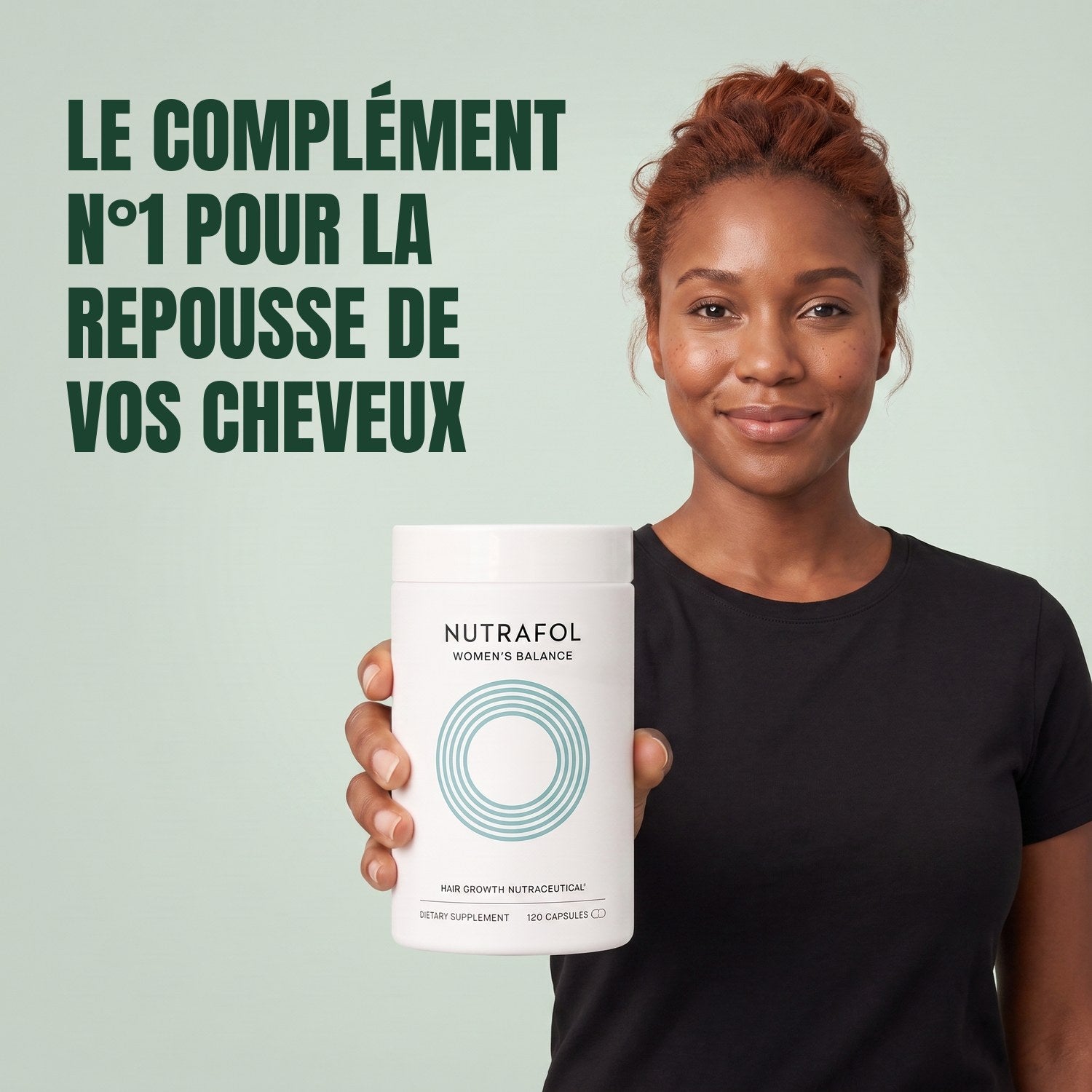 Woman holding the Nutrafol for Women 45+ supplement box against a green background