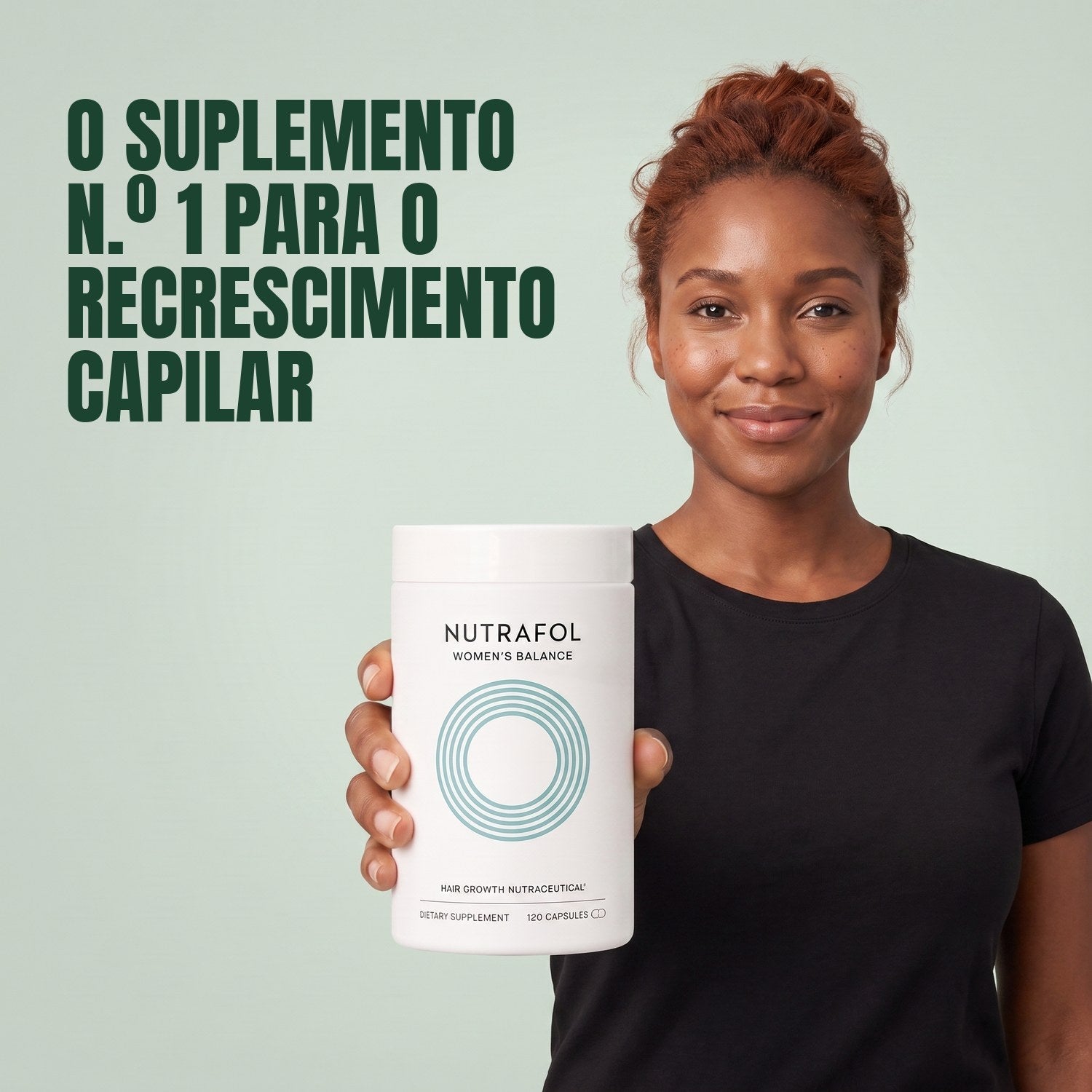 Woman holding the Nutrafol for Women 45+ supplement box against a green background