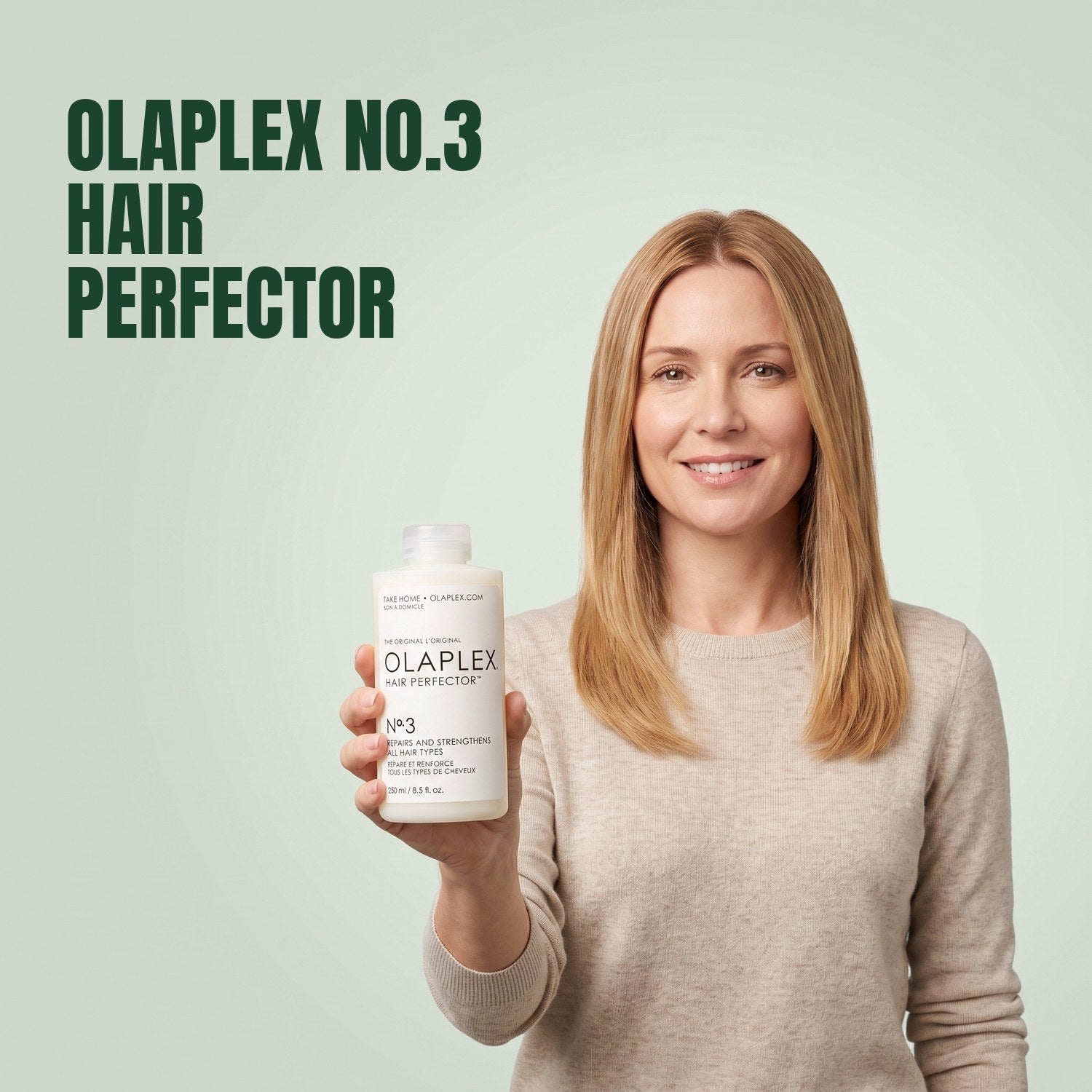 Woman holding Olaplex No.3 Hair Perfector against a green background