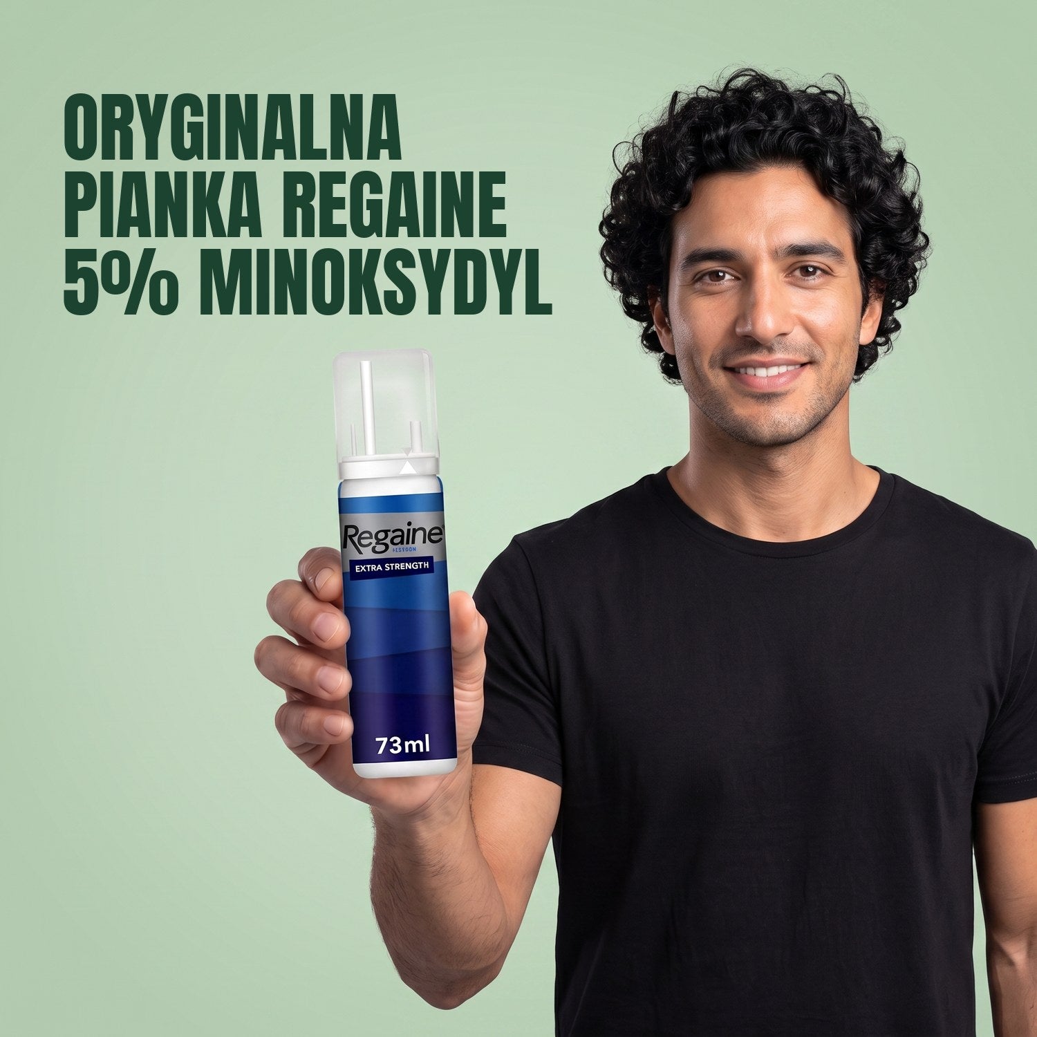 Man holding the Regaine for Men Minoxidil 5% foam pack against a green background