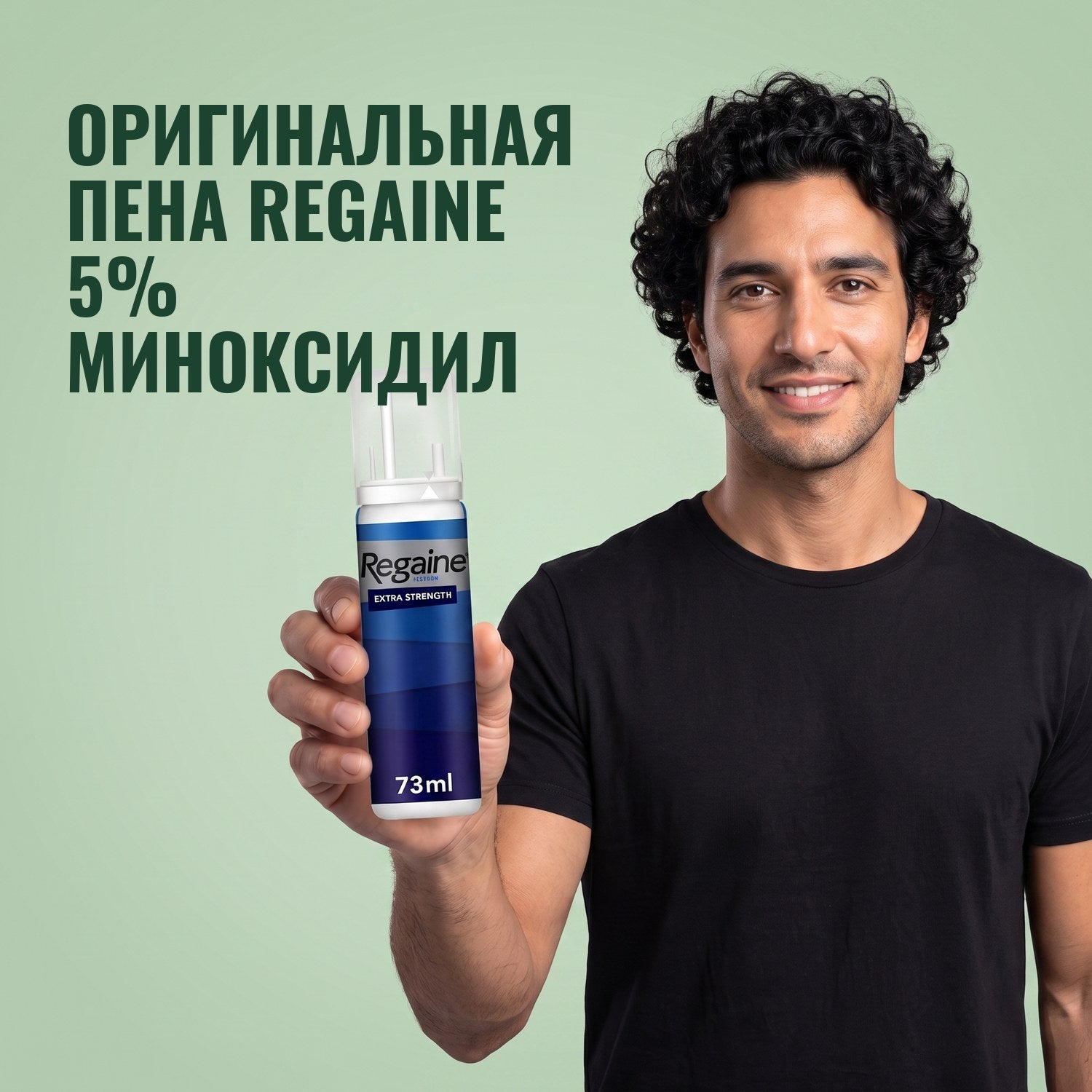 Man holding the Regaine for Men Minoxidil 5% foam pack against a green background