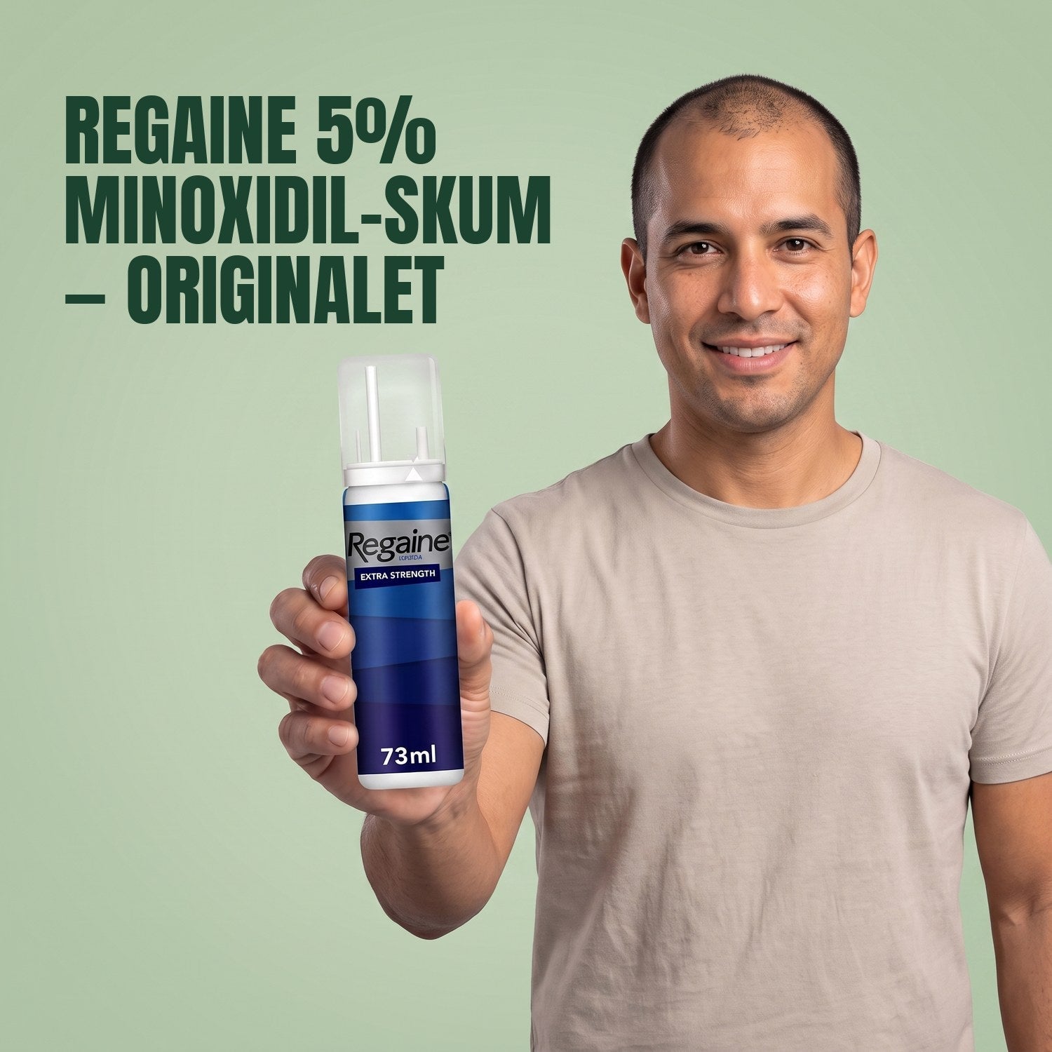 Man holding the Regaine for Men Minoxidil 5% foam pack against a green background
