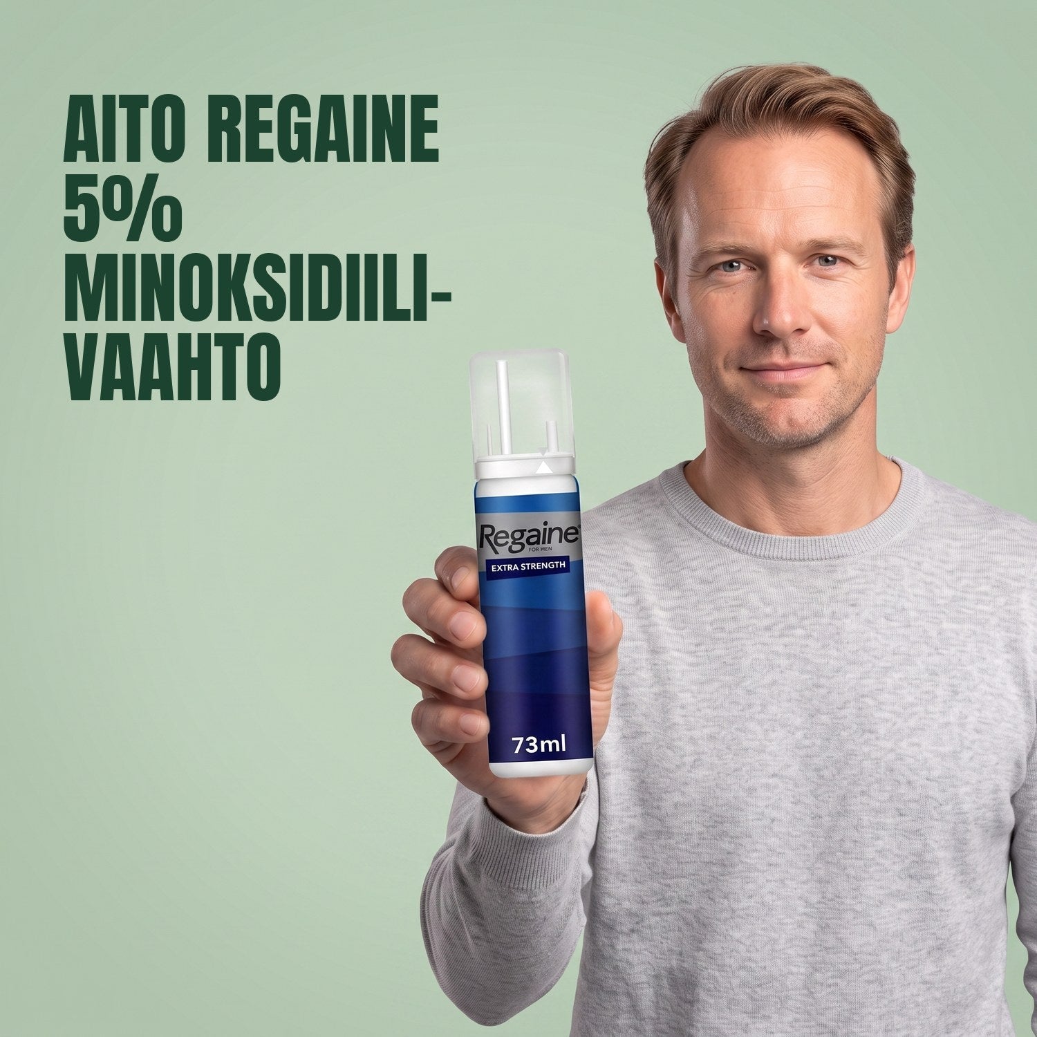 Man holding the Regaine for Men Minoxidil 5% foam pack against a green background
