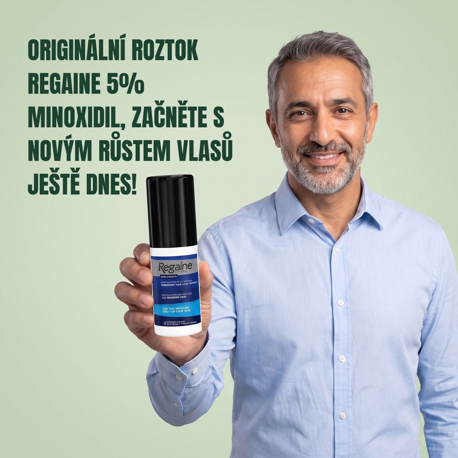 Man holding the Regaine for Men Minoxidil 5% lotion pack against a green background