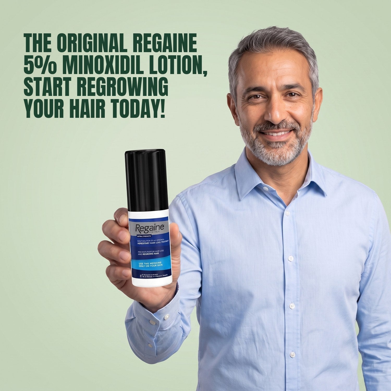 Man holding the Regaine for Men Minoxidil 5% lotion pack against a green background