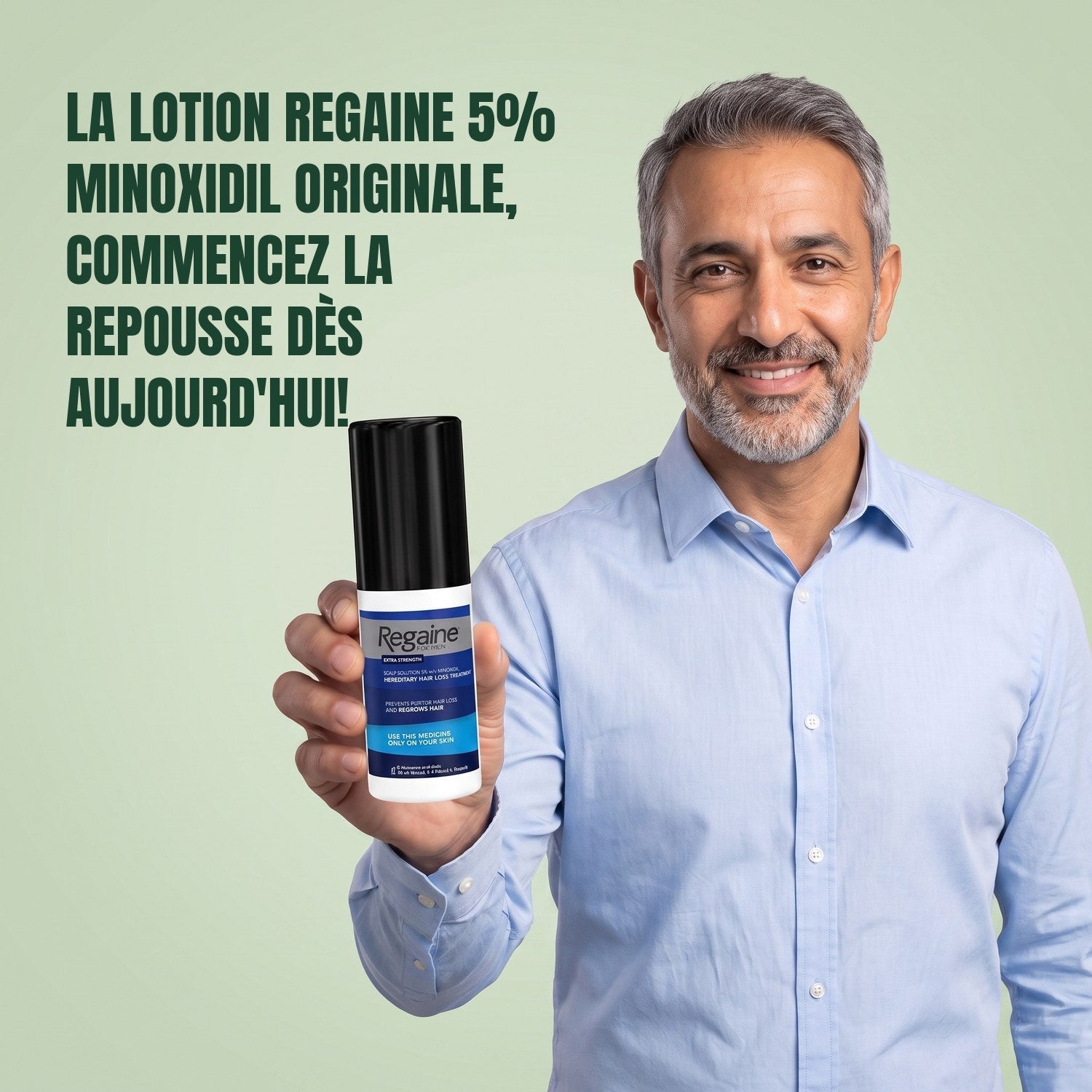 Man holding the Regaine for Men Minoxidil 5% lotion pack against a green background