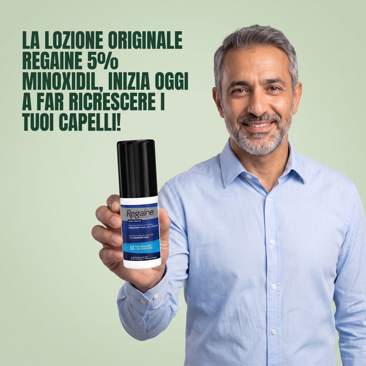 Man holding the Regaine for Men Minoxidil 5% lotion pack against a green background