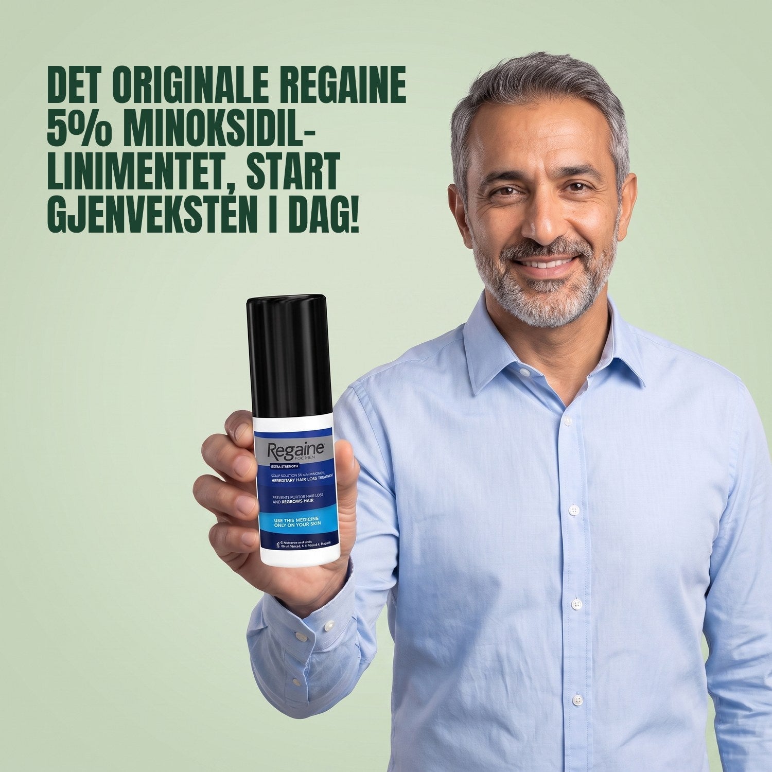 Man holding the Regaine for Men Minoxidil 5% lotion pack against a green background