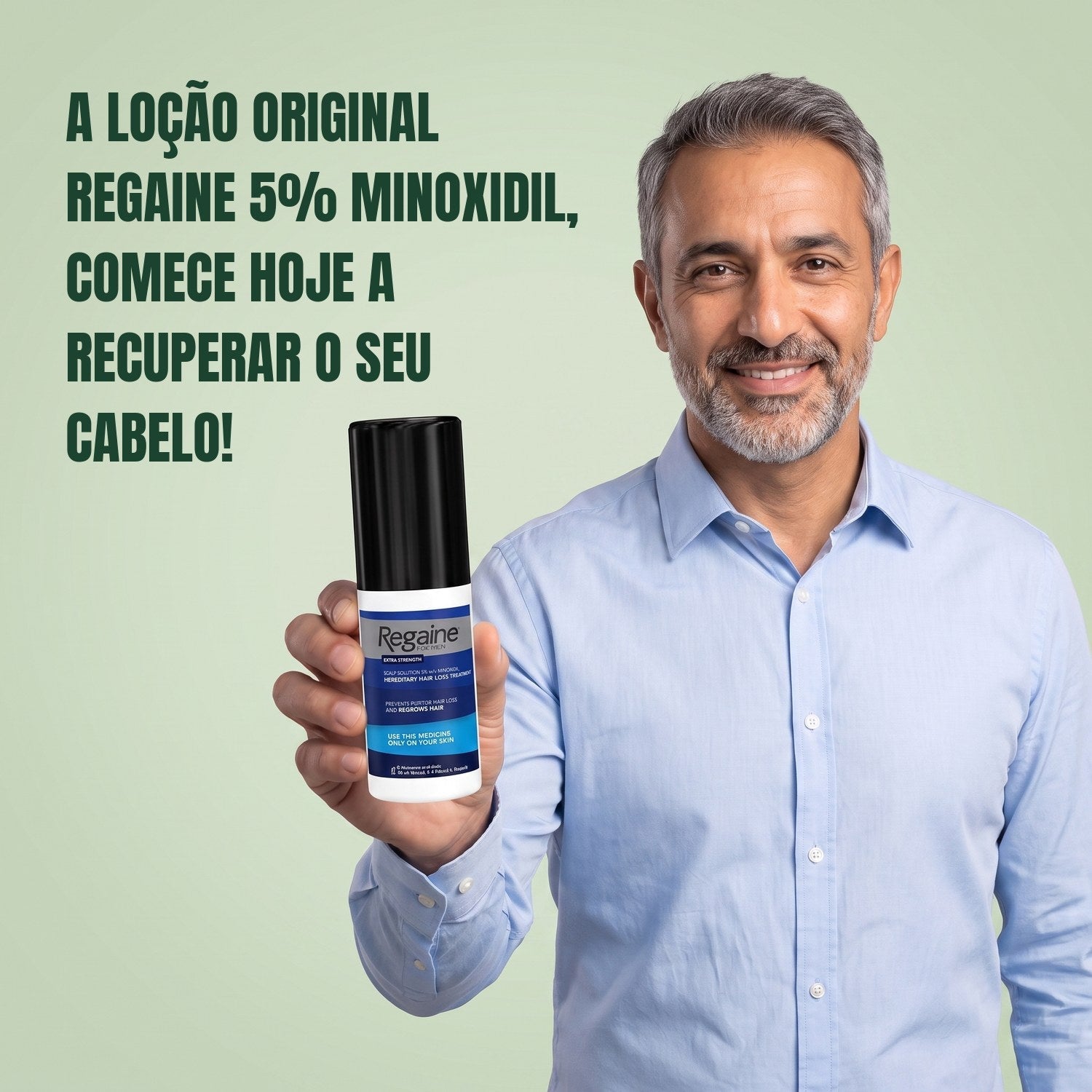 Man holding the Regaine for Men Minoxidil 5% lotion pack against a green background