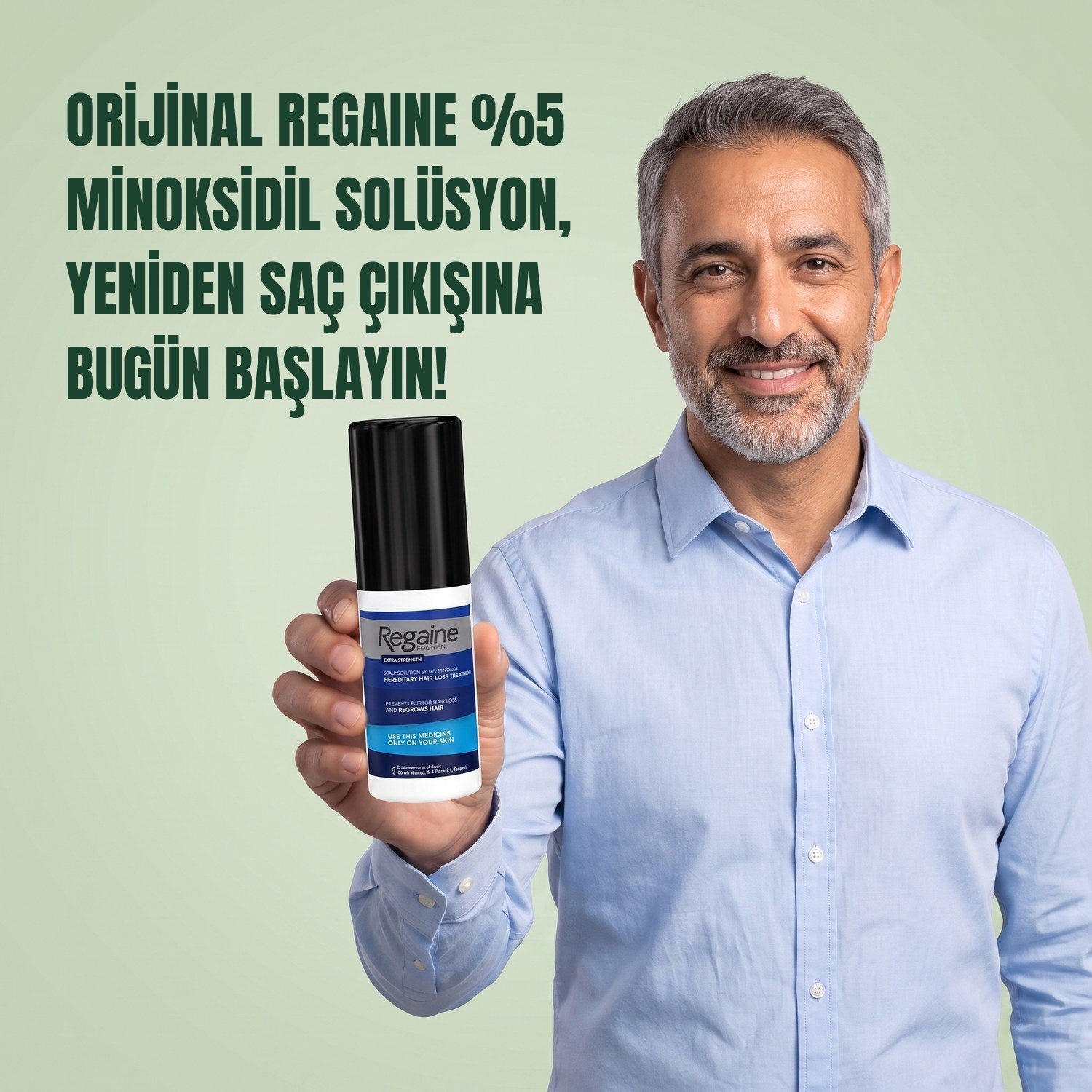 Man holding the Regaine for Men Minoxidil 5% lotion pack against a green background