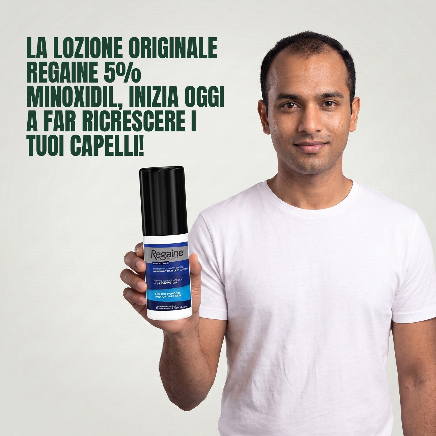 Man holding the Regaine for Men Minoxidil 5% lotion pack against a green background