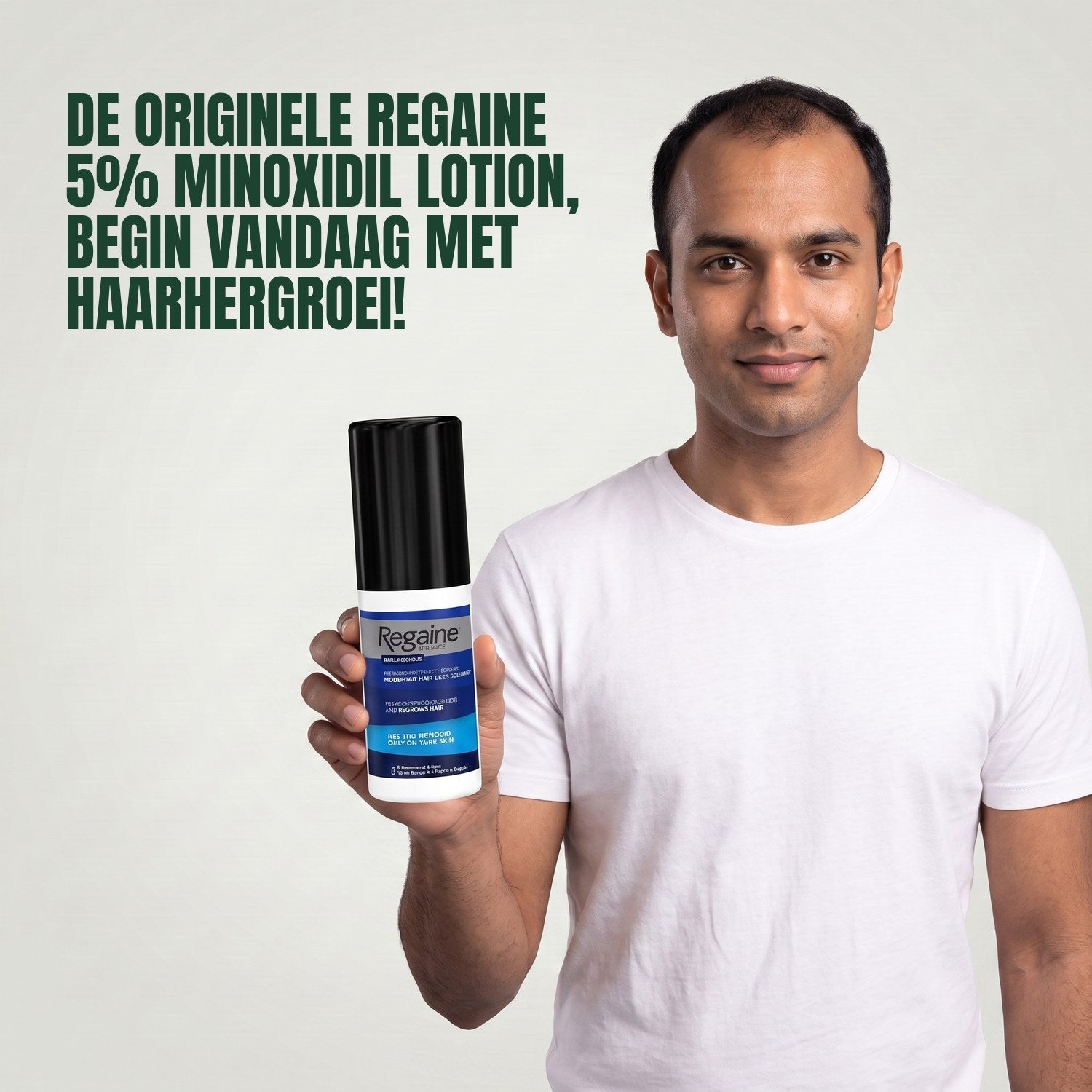 Man holding the Regaine for Men Minoxidil 5% lotion pack against a green background