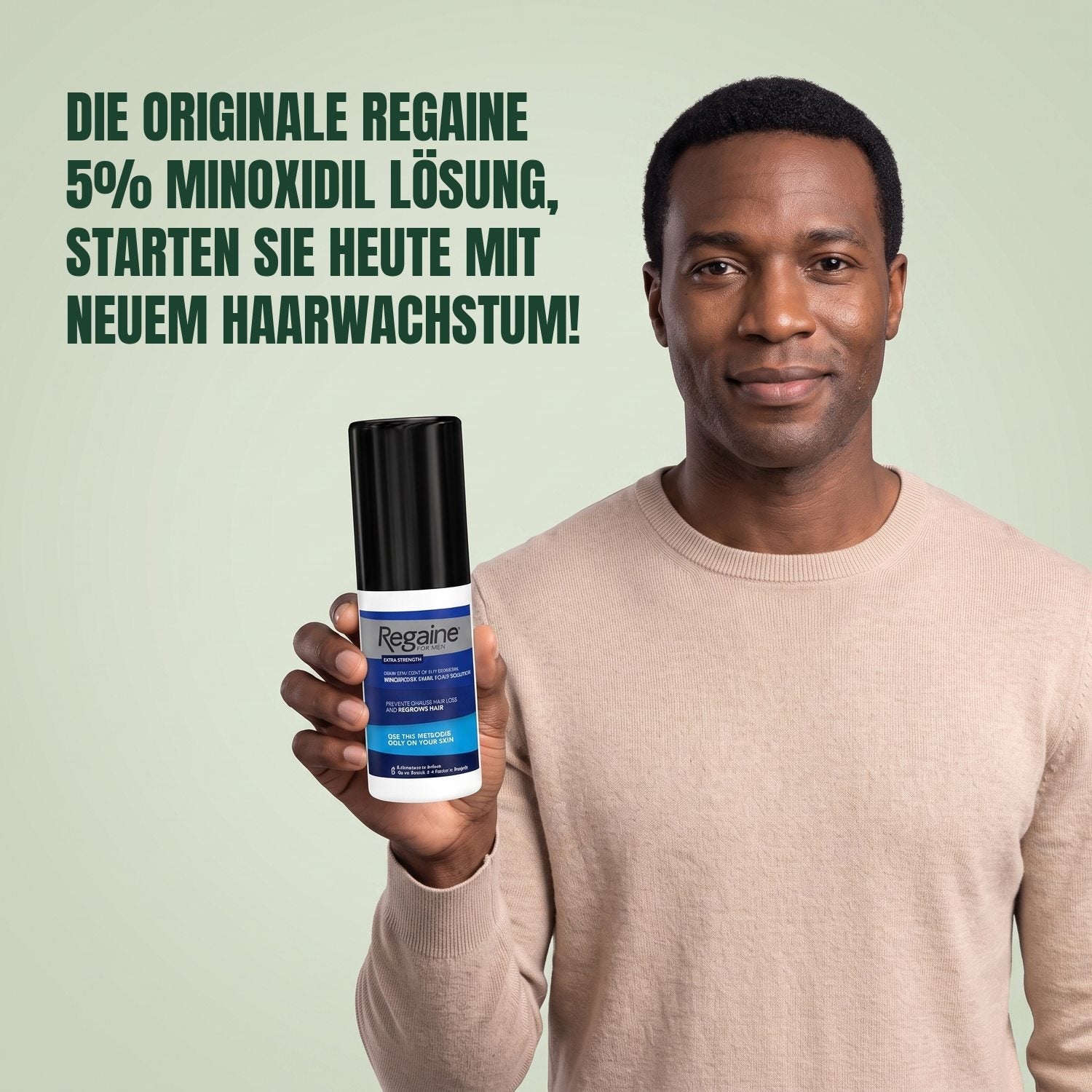 Man holding the Regaine for Men Minoxidil 5% lotion pack against a green background