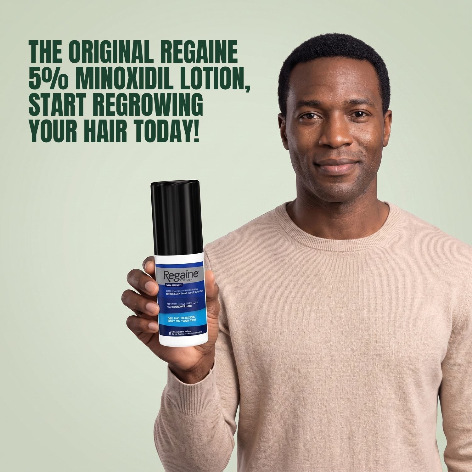 Man holding the Regaine for Men Minoxidil 5% lotion pack against a green background