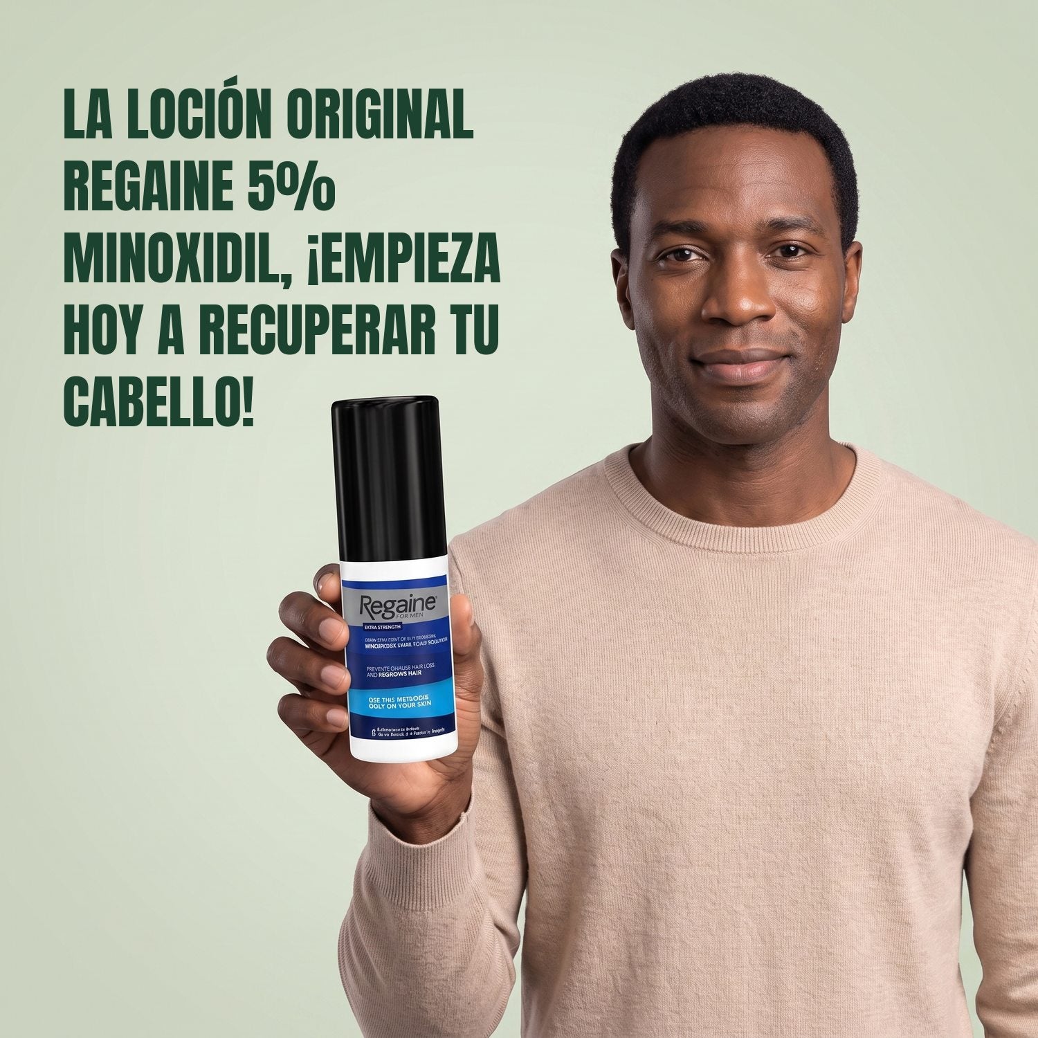 Man holding the Regaine for Men Minoxidil 5% lotion pack against a green background