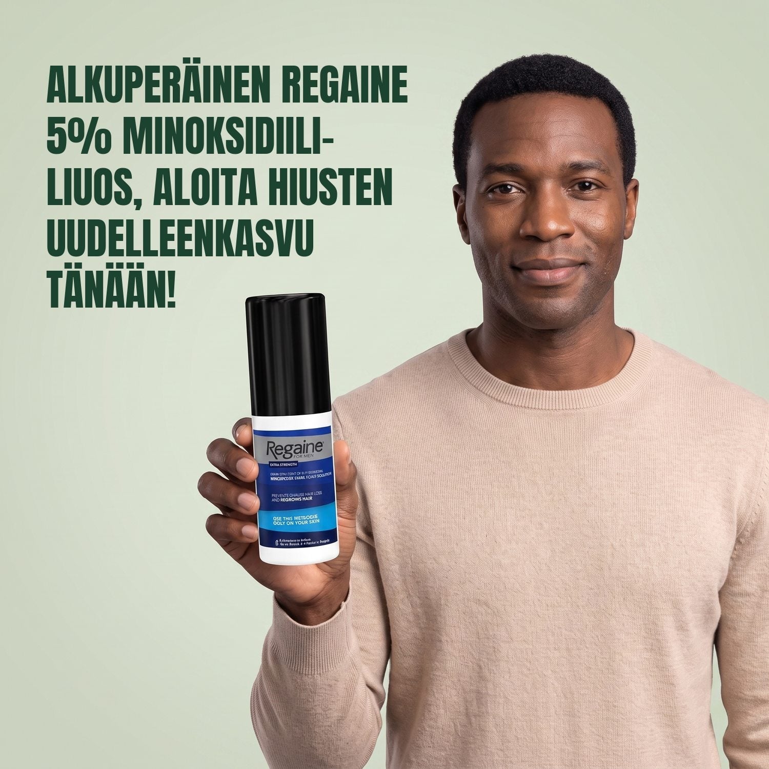 Man holding the Regaine for Men Minoxidil 5% lotion pack against a green background