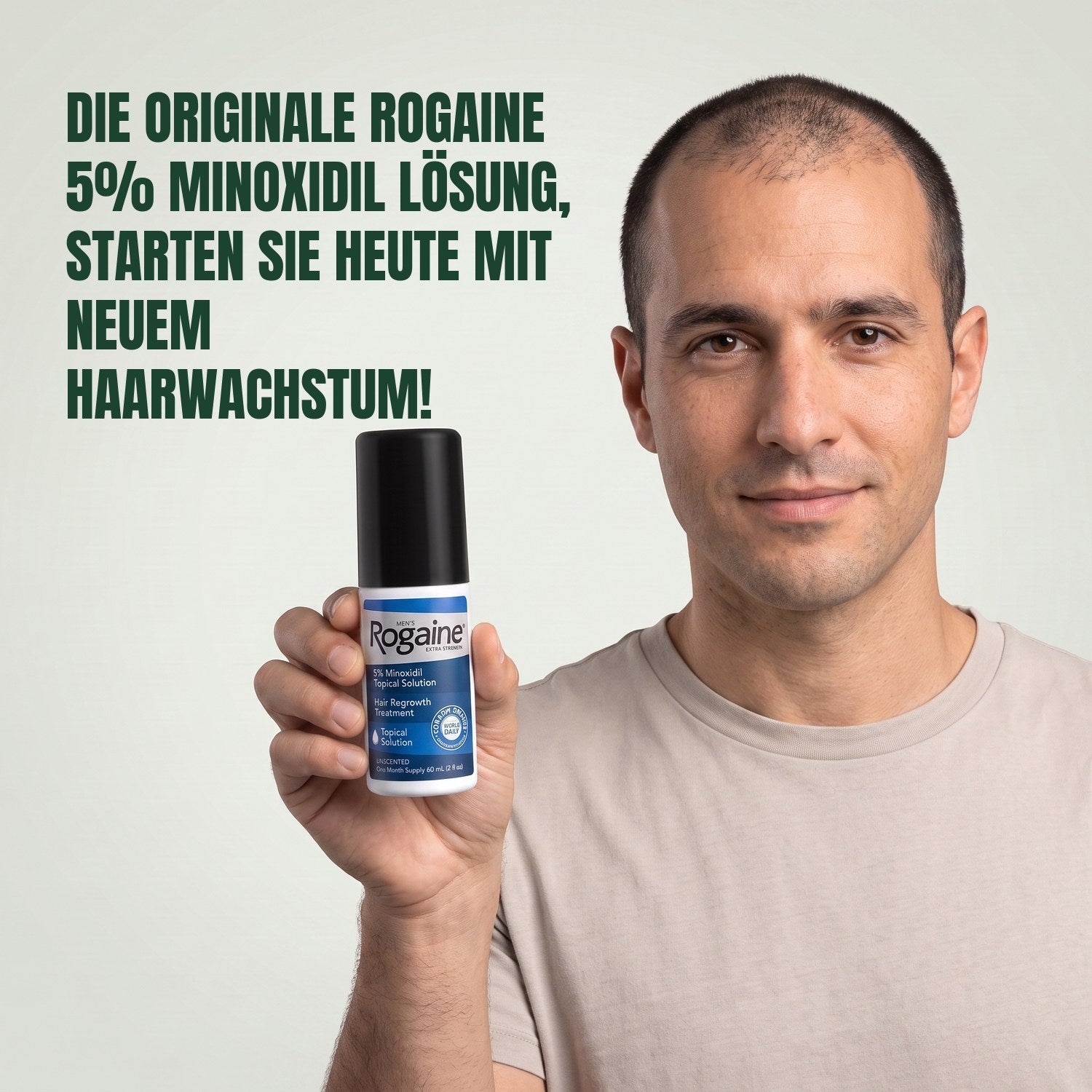 Man holding the Rogaine 5% minoxidil topical solution carton against a green background