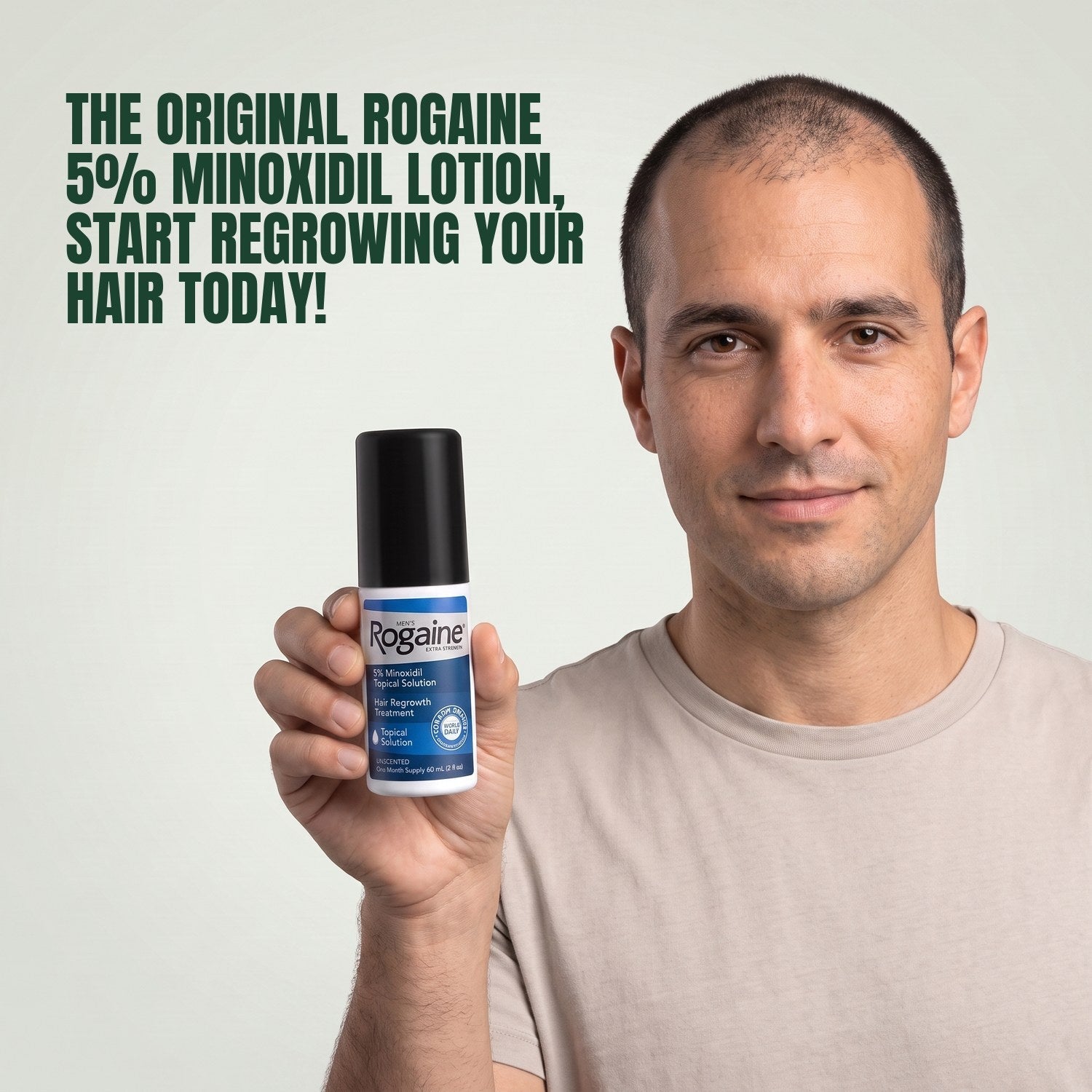 Man holding the Rogaine 5% minoxidil topical solution carton against a green background
