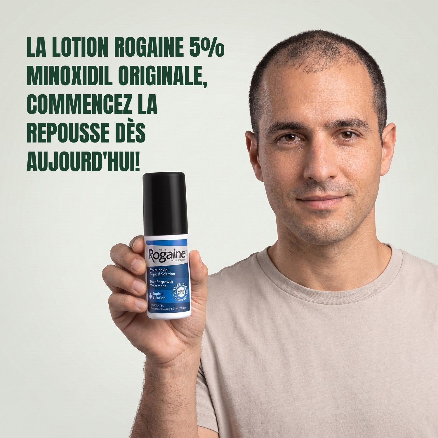 Man holding the Rogaine 5% minoxidil topical solution carton against a green background