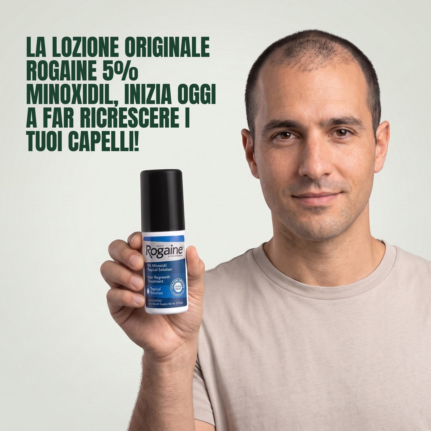 Man holding the Rogaine 5% minoxidil topical solution carton against a green background