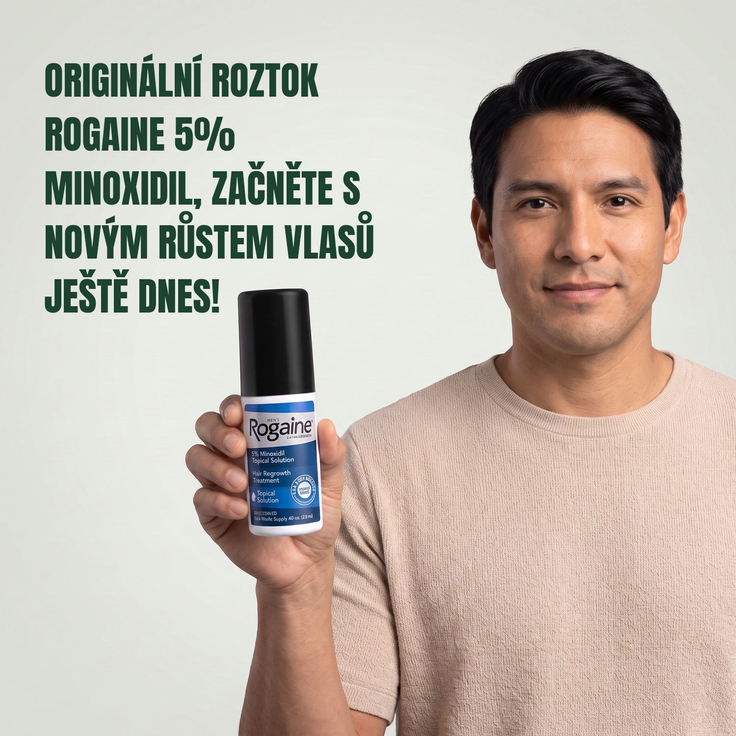 Man holding the Rogaine 5% minoxidil topical solution carton against a green background