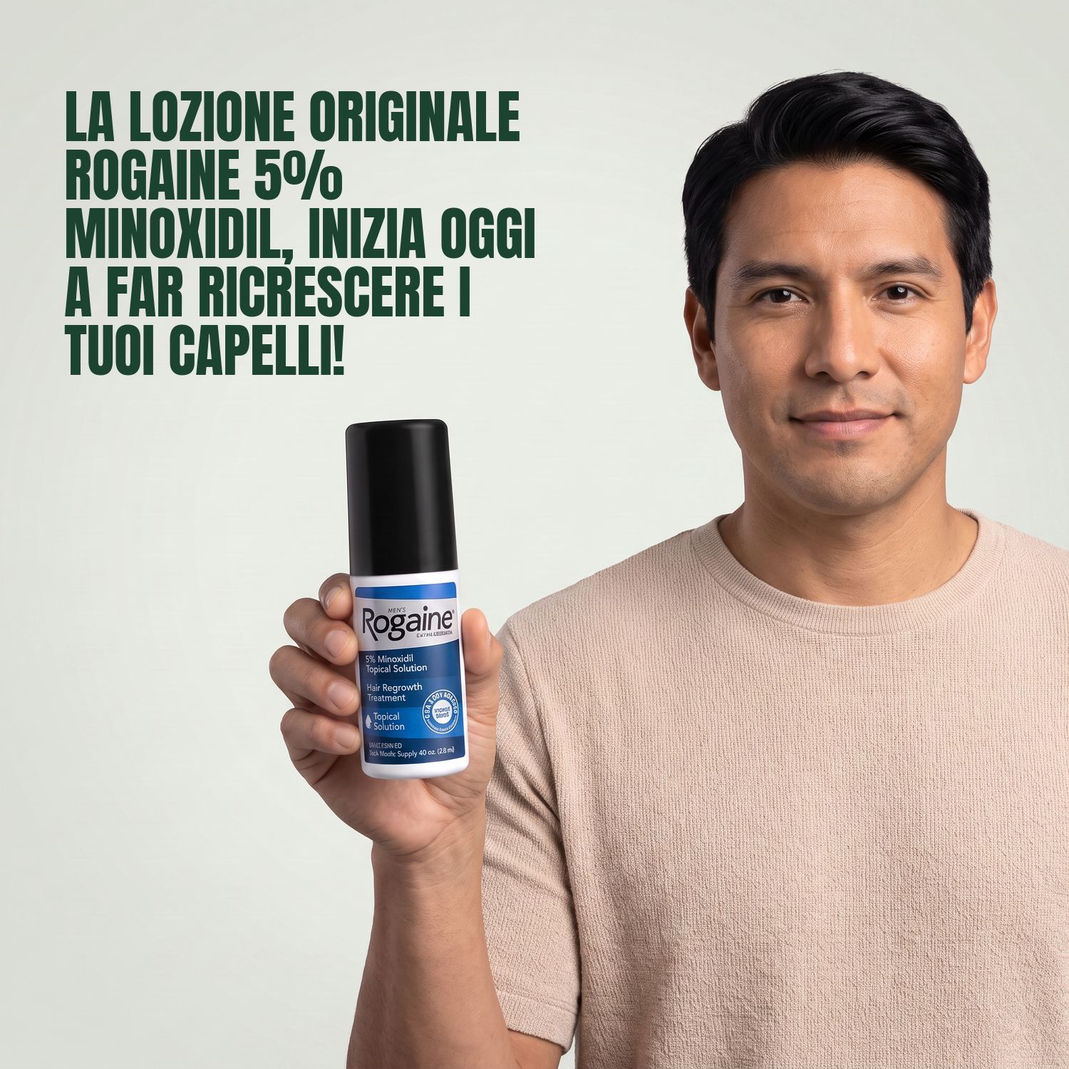 Man holding the Rogaine 5% minoxidil topical solution carton against a green background