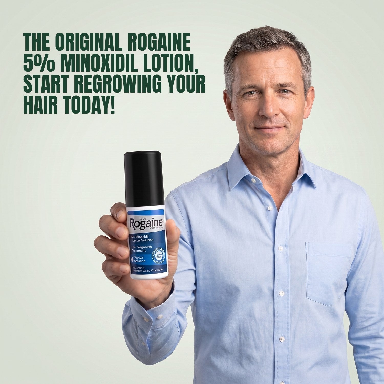 Man holding the Rogaine 5% minoxidil topical solution carton against a green background