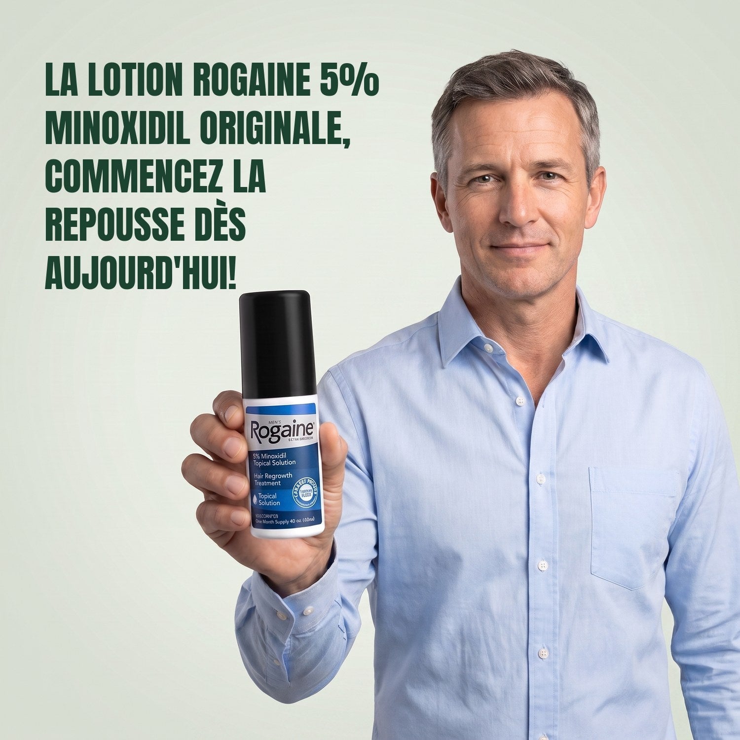 Man holding the Rogaine 5% minoxidil topical solution carton against a green background