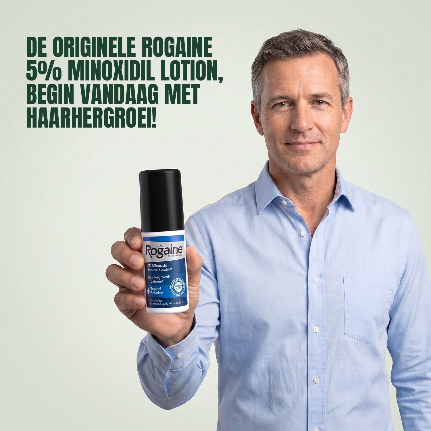 Man holding the Rogaine 5% minoxidil topical solution carton against a green background