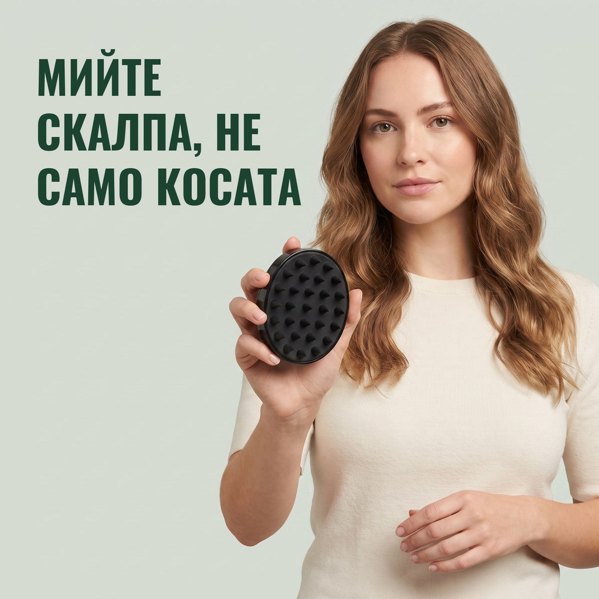 Жена държи четка масажор за скалп на зелен фон
