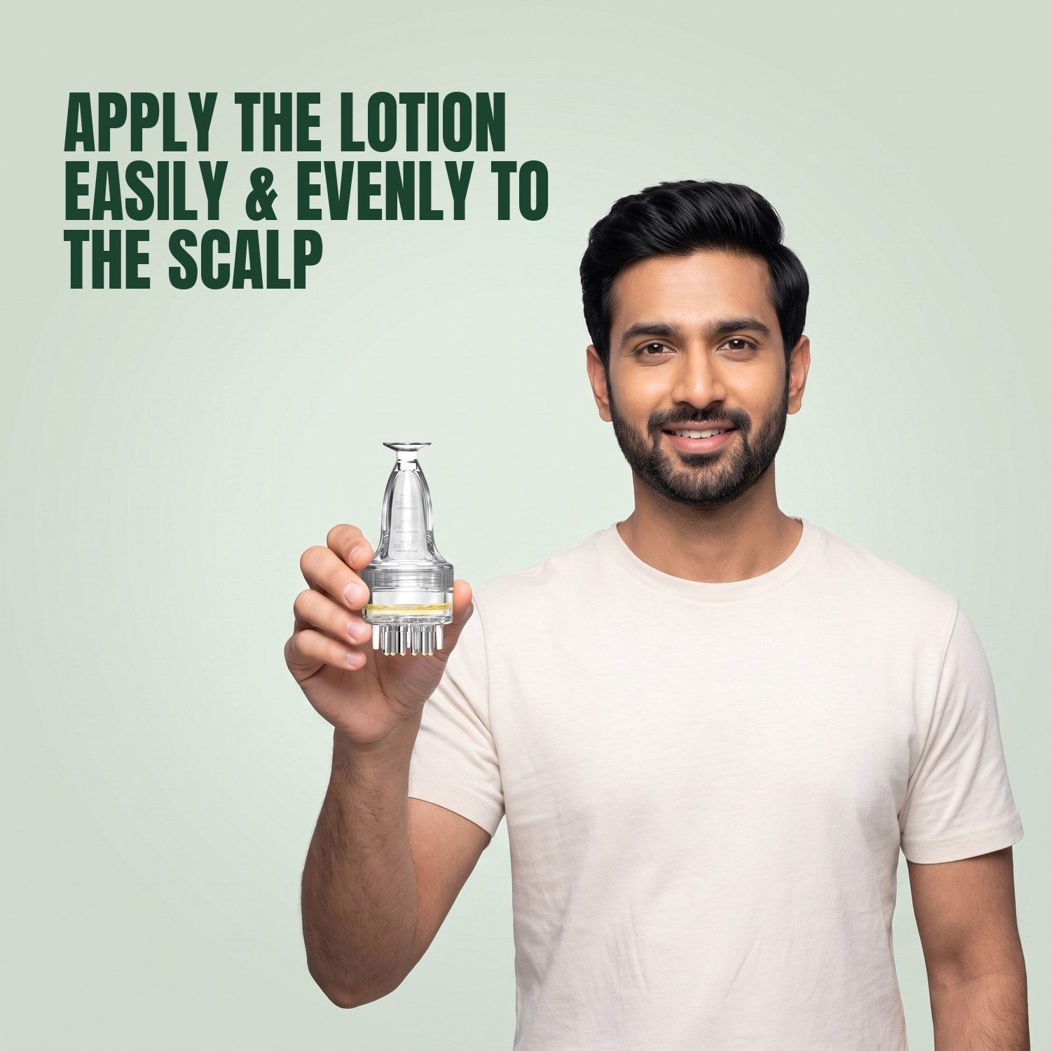 Man holding a basic minoxidil lotion applicator against a green background