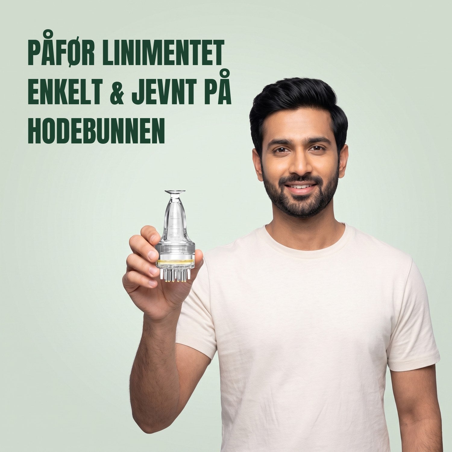 Mann som holder en enkel applikator for minoksidilliniment mot en grønn bakgrunn